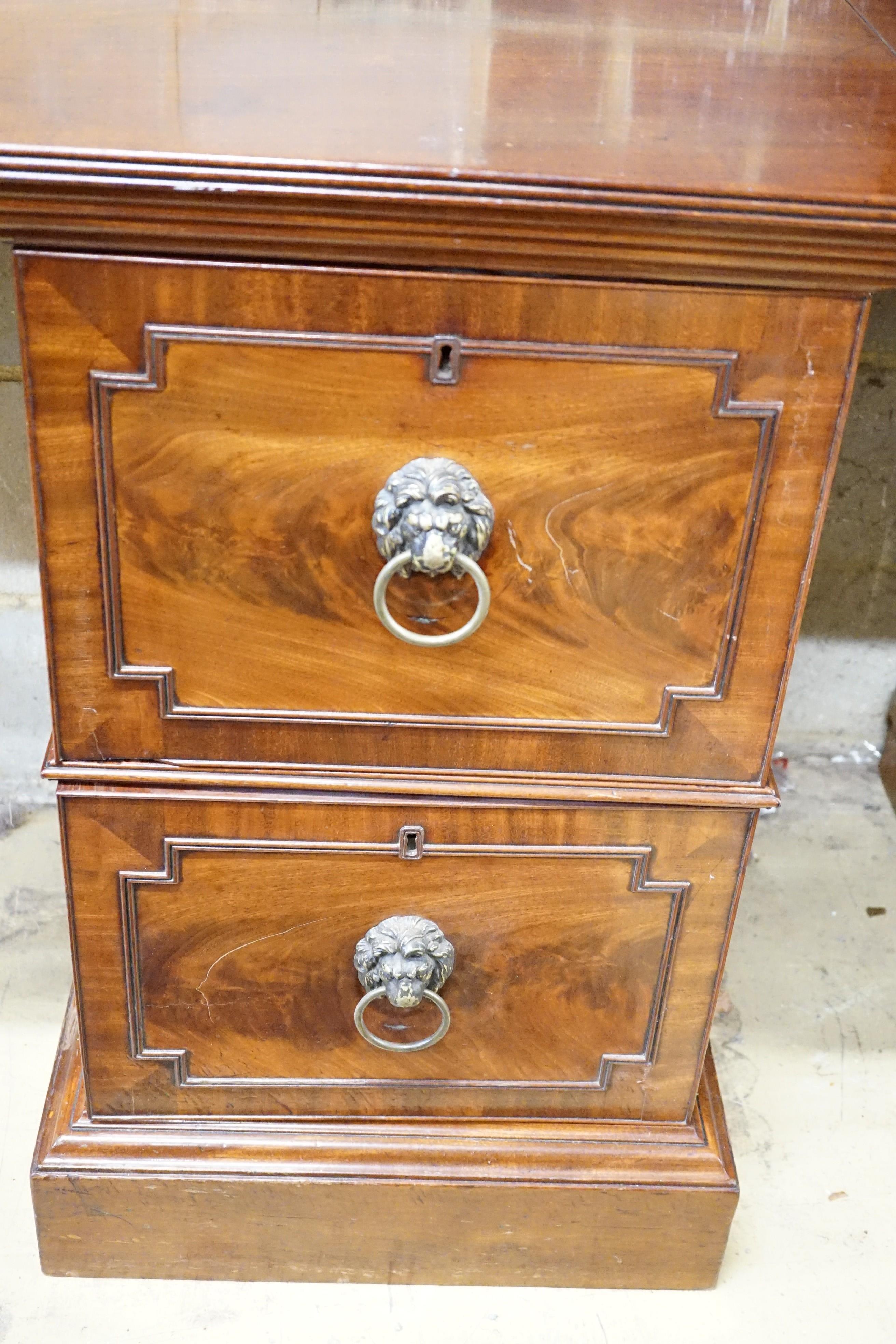 A George III mahogany pedestal designed by C. Wilson, with twin flap top, cellaret drawer now with two decanters and base cupboard, width 53cm, height 87cm